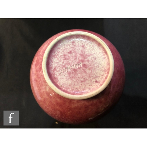 60 - Ruskin Pottery - A vase of globe and shaft form decorated in an all over Strawberry Crush glaze with... 