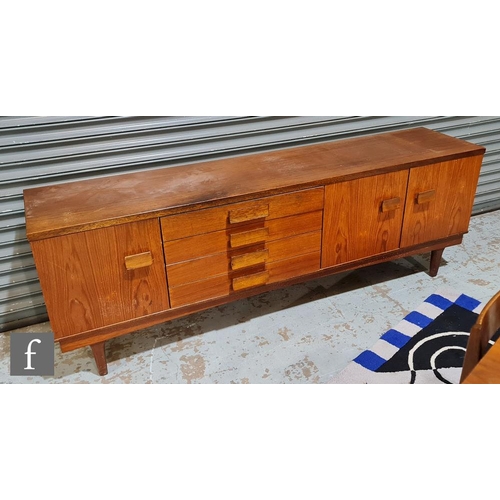 1017 - In the manner of A. Younger - A teak dining suite comprising sideboard, fitted with a central bank o... 