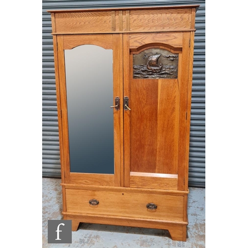 50 - Unknown - An oak wardrobe, the cornice pediment above double doors with a mirror panel and repousse ... 