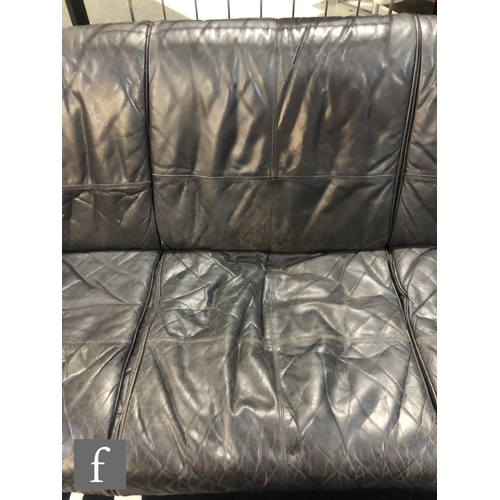 976 - Mark Lawson - Pieff Furniture - A three seat black leather upholstered sofa with chromium plated tub... 