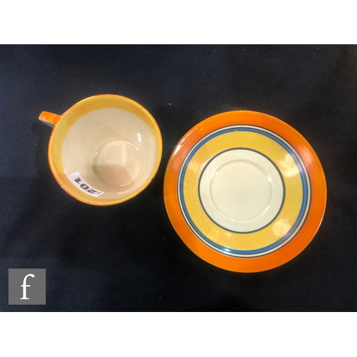 201 - Clarice Cliff - Football - A Conical shape tea cup and saucer circa 1930 hand painted with a block, ... 