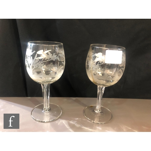 418 - Moser - A pair of clear crystal wine glasses, the optic ribbed ovoid bowl engraved with a tree lands... 