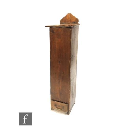 1216 - A 19th Century continental pine floorstanding salt container, the slope top over a short base drawer... 