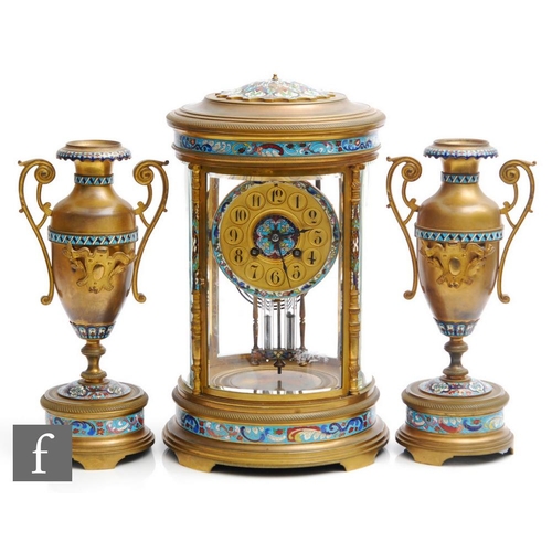 903 - A 19th Century French champleve enamelled brass clock garniture, the eight day movement striking on ... 