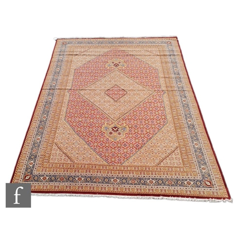 975 - An very large Bidjar carpet, the hand knotted wool rug with central diamond design, within a series ... 