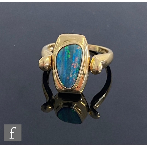 544 - A 14ct swivel ring with collar set opal to one side and a cushioned rectangular mother of pearl pane... 