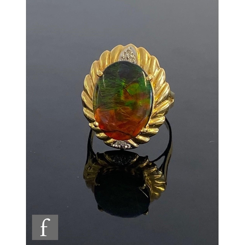 547 - An 18ct water opal doublet set ring with central oval claw set opal within a fluted gold border deta... 