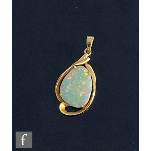 552 - A 14ct single stone opal pendant, claw set shaped oval stone within a plain scroll border, weight 2.... 