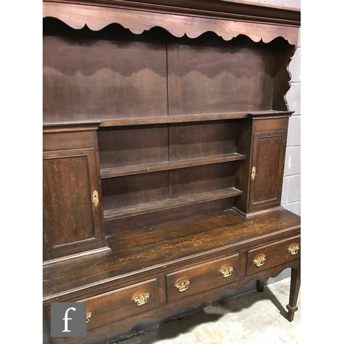 1234 - An early 20th Century oak dresser in the Georgian style, the upright section with shaped cornice fri... 