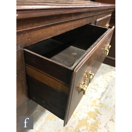 1234 - An early 20th Century oak dresser in the Georgian style, the upright section with shaped cornice fri... 