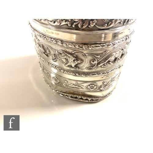 361 - A hallmarked silver oval tea caddy with banded embossed foliate scroll decoration to body and pull o... 