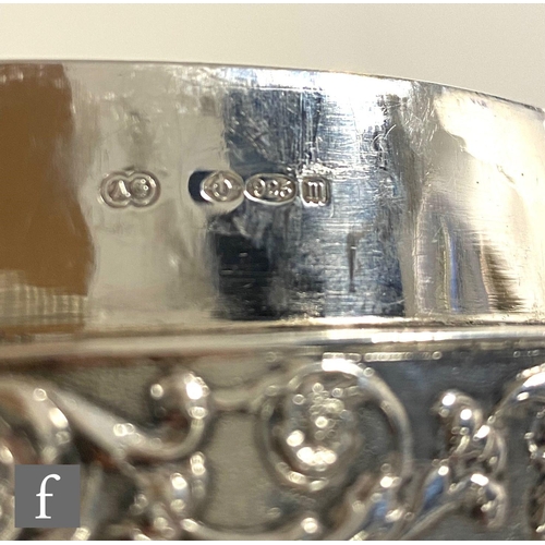 361 - A hallmarked silver oval tea caddy with banded embossed foliate scroll decoration to body and pull o... 