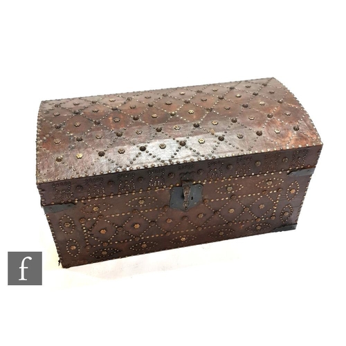 1219 - An early to mid 20th Century domed Moorish leather covered iron studded trunk, the front decorated w... 