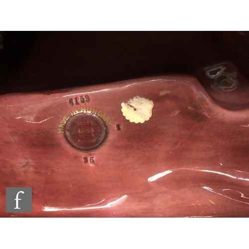 129 - A large Zsolnay eosin glaze model of a tiger reclining on a rock, inscribed Tigus regalis to the fro... 