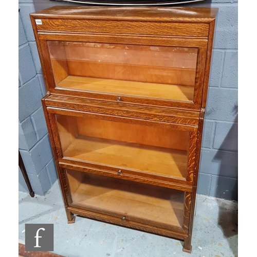 1232 - An early to mid 20th Century three-tier 'Gumm' oak glazed bookcase, height 140cm x depth 31cm x widt... 