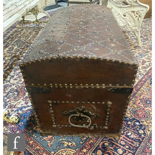 1219 - An early to mid 20th Century domed Moorish leather covered iron studded trunk, the front decorated w... 