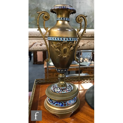 903 - A 19th Century French champleve enamelled brass clock garniture, the eight day movement striking on ... 