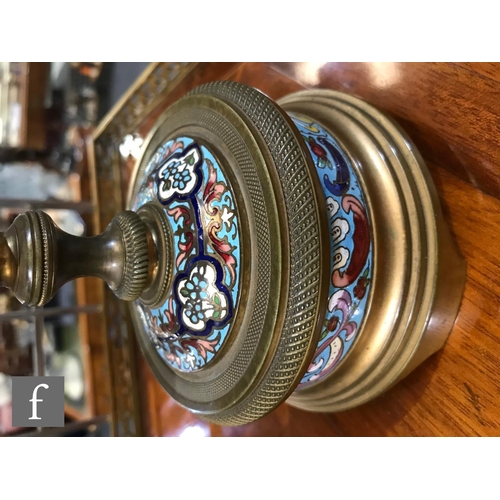 903 - A 19th Century French champleve enamelled brass clock garniture, the eight day movement striking on ... 