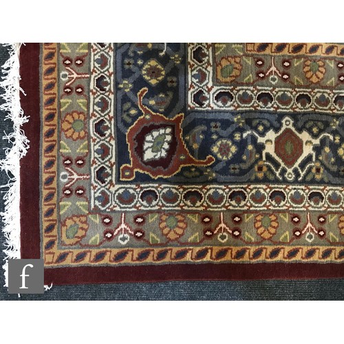 975 - An very large Bidjar carpet, the hand knotted wool rug with central diamond design, within a series ... 