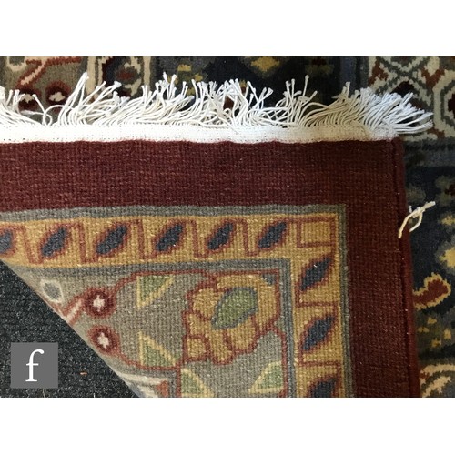 975 - An very large Bidjar carpet, the hand knotted wool rug with central diamond design, within a series ... 