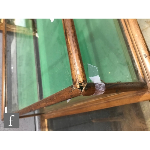 1231 - A 19th Century mahogany flat top glazed display cabinet with green baize lining and two back drop do... 