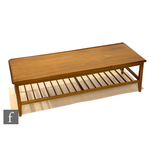 1241 - A 1960s teak coffee table of rectangular form with ladder type magazine rack below, unlabelled, heig... 