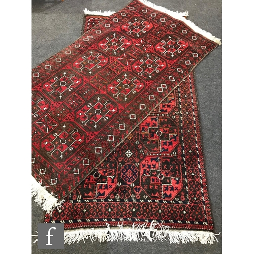 1238 - Two mid 20th Century Middle Eastern rugs, each decorated with ten medallions on a red ground within ... 