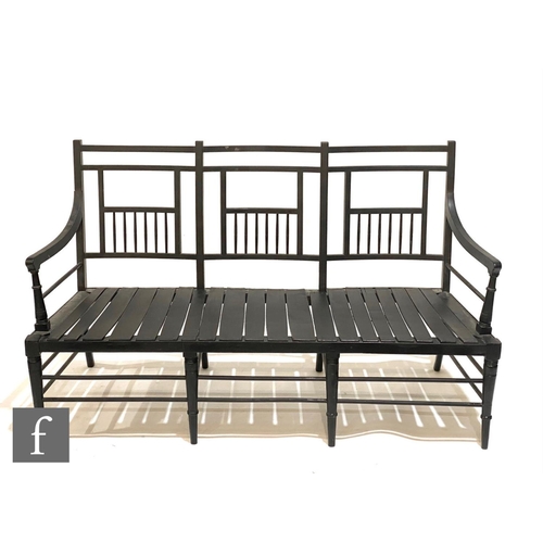 1237 - A late 19th Century Sussex type ebonised three seat settee, with turned spindles to the back rails a... 