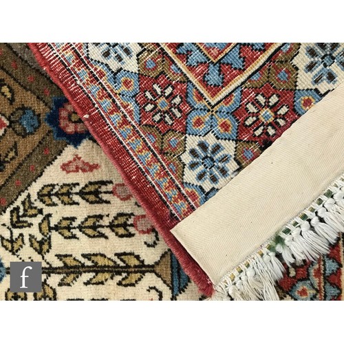 1240 - A 1960s Persian Koum or Kum carpet of red, salmon pink, blue and oatmeal colours, the central diamon... 