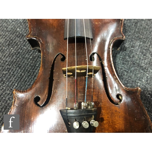 943 - A late 19th to early 20th Century violin with spruce sound board and one piece maple back, bearing s... 