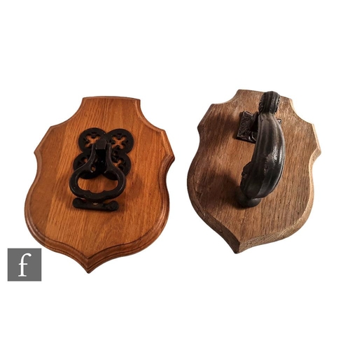 944 - Two late Victorian cast iron door knockers, the first with a quatrefoil pierced back and trefoil sha... 