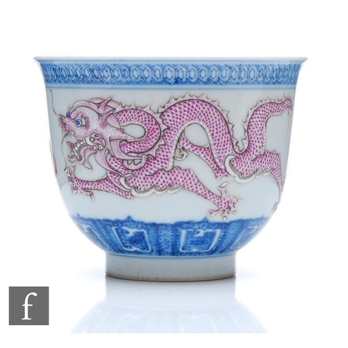 206 - A Chinese late Qing Dynasty blue and white porcelain dragon bowl, the 'U' form bowl rising from a hi... 