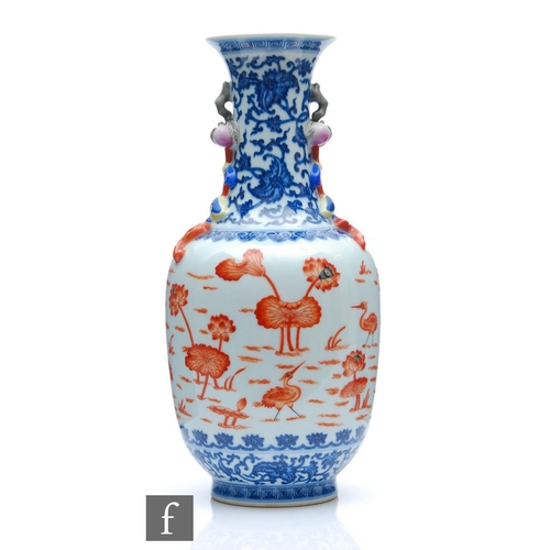 212 - A Chinese blue and white porcelain vase of bottle form applied with iron-red enamels to the central ... 