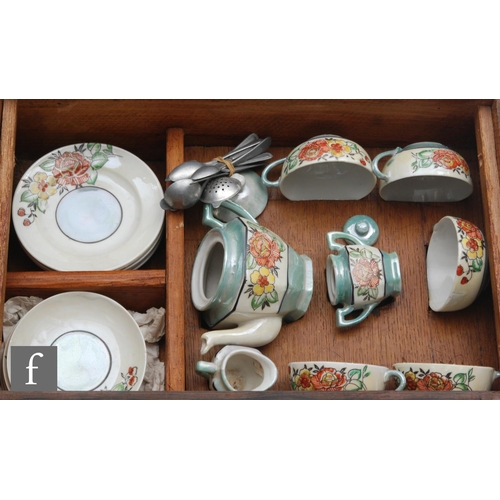 141 - A vintage childrens teaset comprising teapot, milk jug, sugar bowl, five cups, five saucers and six ... 