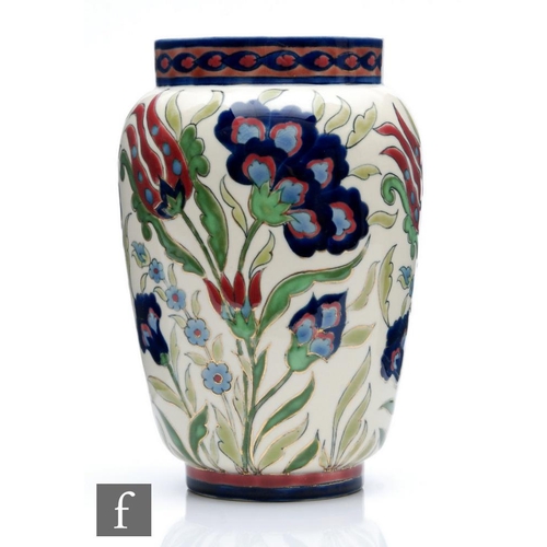 41 - A Zsolnay Pecs barrel vase decorated in the Persian style with tulip and carnations in tones of red ... 