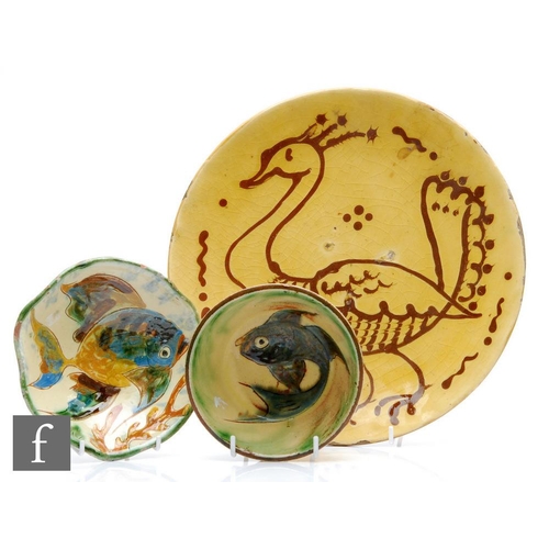 45 - An early to mid 20th Century shallow dish slip decorated with a bird in brown against a mustard yell... 