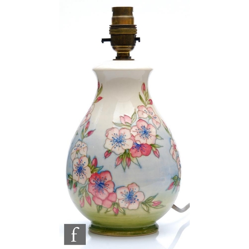 49 - A Moorcroft Pottery table lamp decorated in the Apple Blossom pattern designed by Sally Tuffin, impr... 