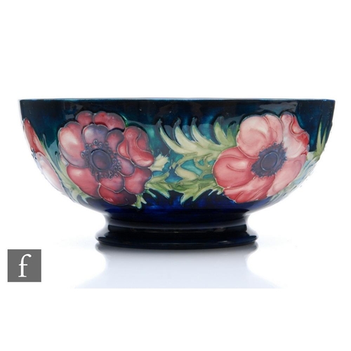 7 - A Moorcroft footed bowl decorated in the Anemone pattern with tubelined flowers to the exterior and ... 