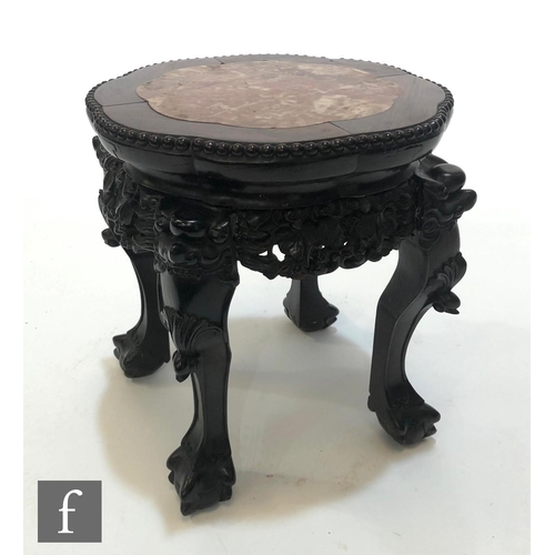 233 - A Chinese Huanghuali style jardiniere stand, the lotus form upper top with rouge marble insert, rais... 