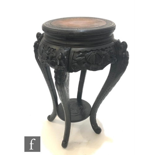 234 - A Chinese carved wooden jardiniere stand, the circular top with four carved tapered supports, united... 