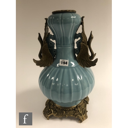 194 - A Chinese Robin's Egg blue porcelain vase of bottle form, rising to a garlic head, applied with reli... 