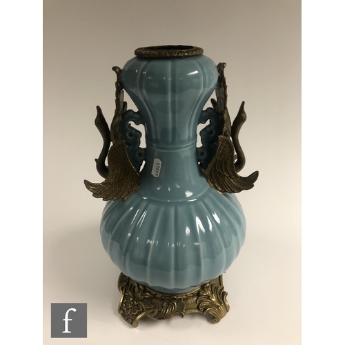 194 - A Chinese Robin's Egg blue porcelain vase of bottle form, rising to a garlic head, applied with reli... 