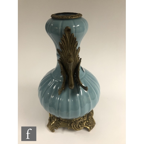 194 - A Chinese Robin's Egg blue porcelain vase of bottle form, rising to a garlic head, applied with reli... 