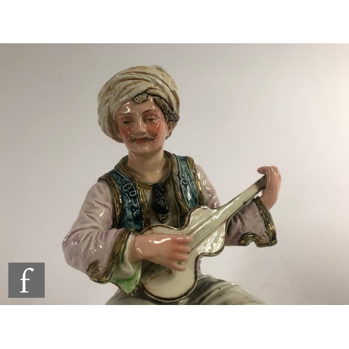 118 - A late 19th to early 20th Century continental figure of a Turkish man sat playing a guitar, unmarked... 