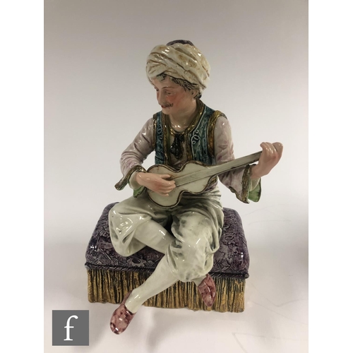 118 - A late 19th to early 20th Century continental figure of a Turkish man sat playing a guitar, unmarked... 