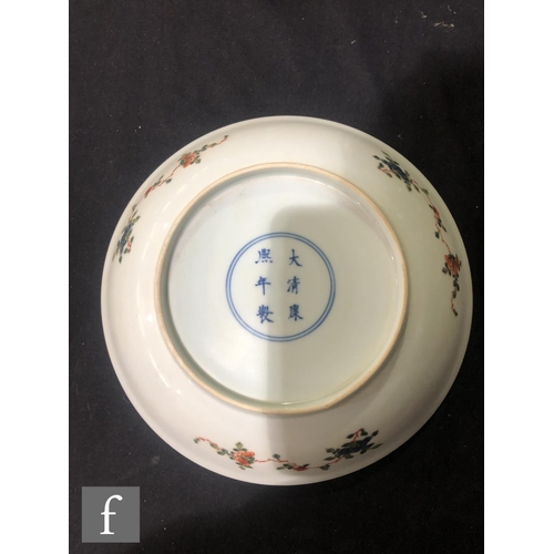 225 - A set of eight Chinese famille verte dishes, each of circular form, the shallow well of each decorat... 