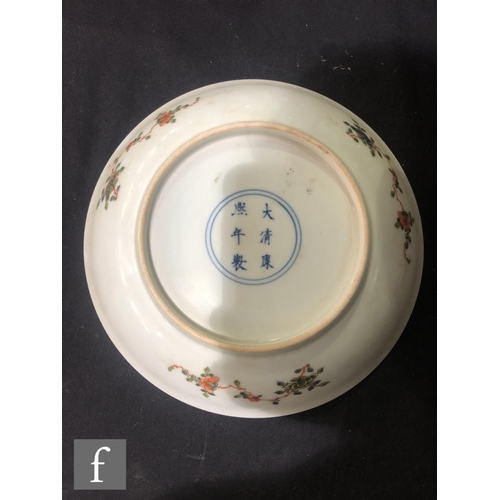 225 - A set of eight Chinese famille verte dishes, each of circular form, the shallow well of each decorat... 