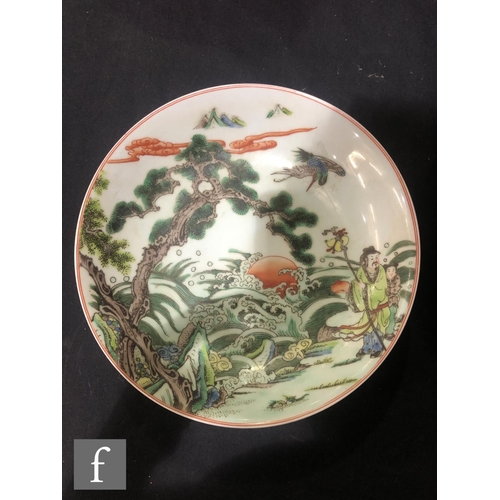 225 - A set of eight Chinese famille verte dishes, each of circular form, the shallow well of each decorat... 