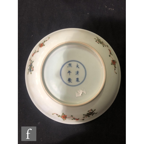 225 - A set of eight Chinese famille verte dishes, each of circular form, the shallow well of each decorat... 