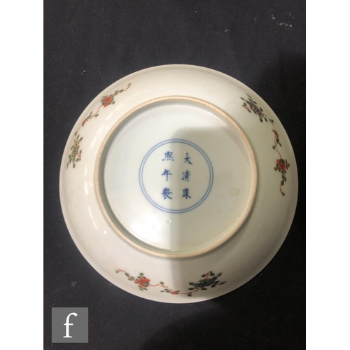 225 - A set of eight Chinese famille verte dishes, each of circular form, the shallow well of each decorat... 